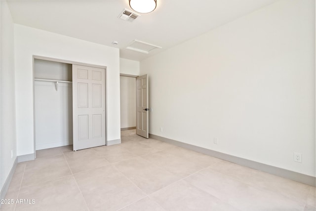 3520 N 110th Ave, Avondale, AZ 85392 - unfurnished bedroom with attic access, baseboards, light tile patterned flooring, visible vents, and a closet