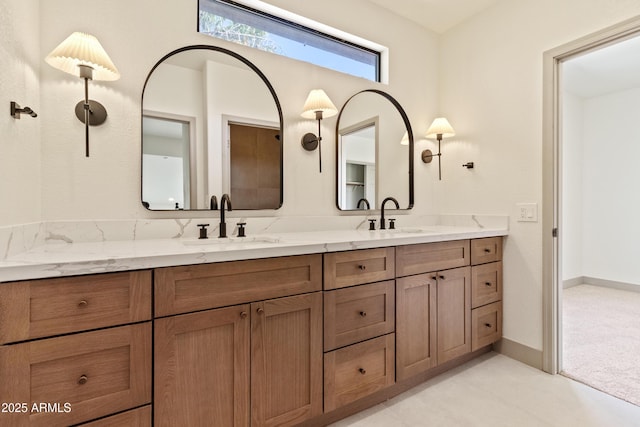 3520 N 110th Ave, Avondale, AZ 85392 - bathroom with double vanity, a sink, and baseboards