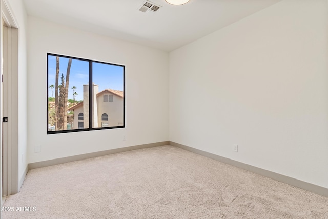 3520 N 110th Ave, Avondale, AZ 85392 - spare room featuring baseboards, visible vents, and carpet