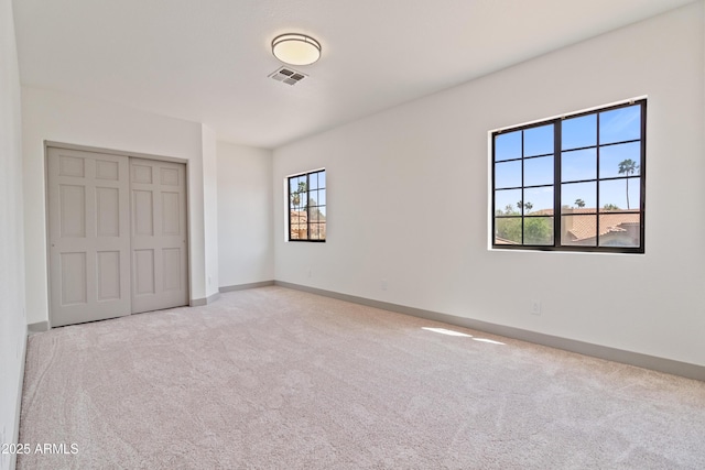3520 N 110th Ave, Avondale, AZ 85392 - unfurnished bedroom featuring a closet, carpet, baseboards, and visible vents