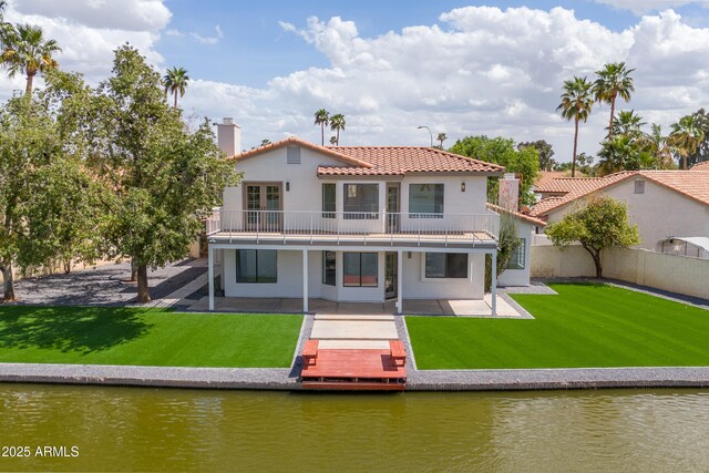 3520 N 110th Ave, Avondale, AZ 85392 - back of house with a patio, a tile roof, a lawn, and a water view