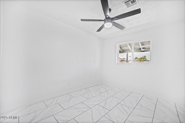 empty room with visible vents, baseboards, ceiling fan, marble finish floor, and a textured ceiling