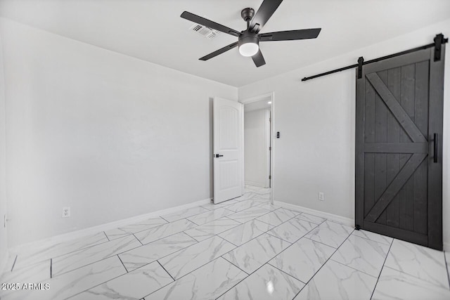 unfurnished bedroom with baseboards, visible vents, ceiling fan, a barn door, and marble finish floor