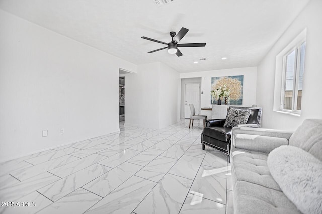 living room with visible vents, marble finish floor, and ceiling fan