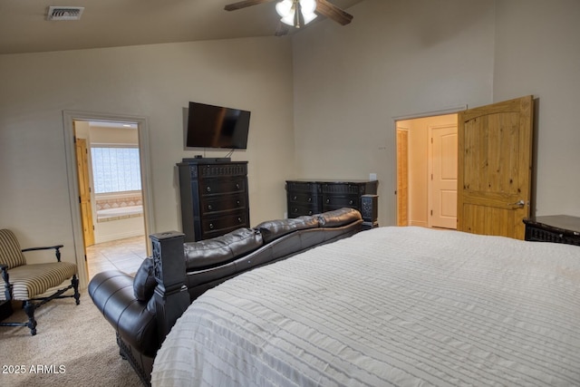 carpeted bedroom with connected bathroom, ceiling fan, and lofted ceiling