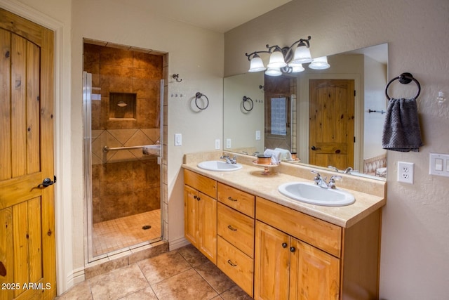 bathroom featuring tile patterned floors, vanity, and a shower with shower door