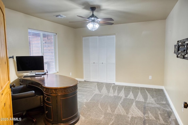 carpeted office space with ceiling fan