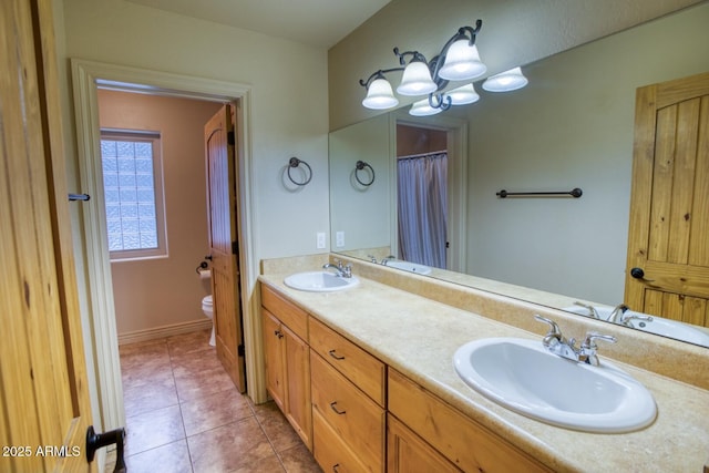 bathroom with tile patterned floors, vanity, and toilet