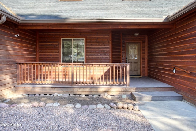 view of exterior entry with covered porch