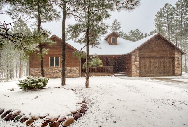 view of snowy exterior with a garage