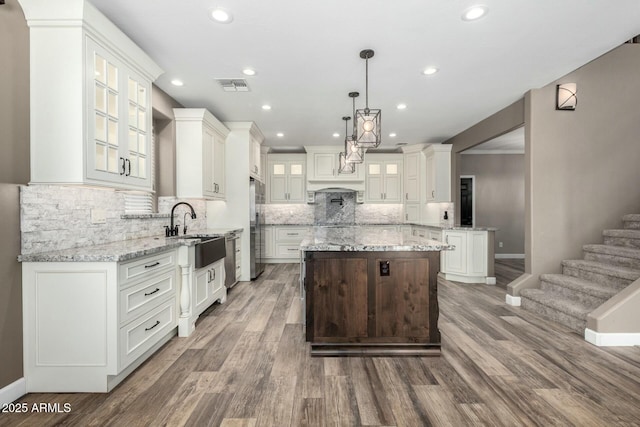 1051 E Julie Ave, San Tan Valley, AZ 85140 - kitchen with visible vents, a sink, wood finished floors, stainless steel appliances, and a kitchen island