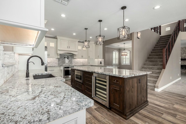 1051 E Julie Ave, San Tan Valley, AZ 85140 - kitchen featuring a sink, dark brown cabinetry, white cabinetry, stainless steel appliances, and beverage cooler