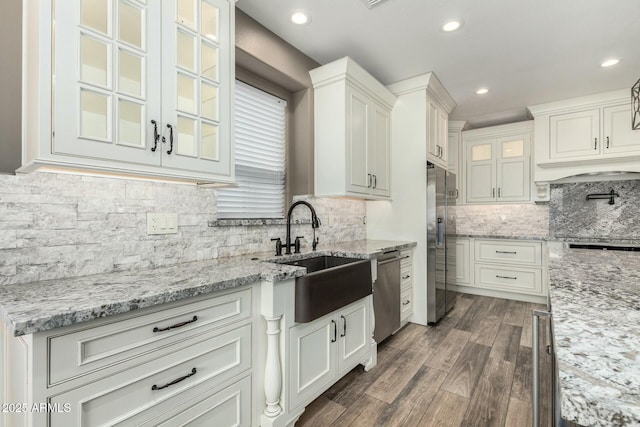 1051 E Julie Ave, San Tan Valley, AZ 85140 - kitchen with glass insert cabinets, a sink, appliances with stainless steel finishes, dark wood-style floors, and white cabinetry