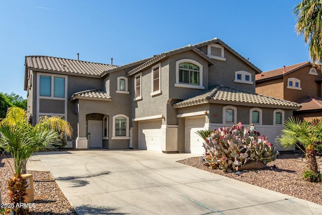 1051 E Julie Ave, San Tan Valley, AZ 85140 - mediterranean / spanish-style house with a tiled roof, an attached garage, concrete driveway, and stucco siding