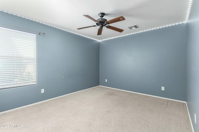 1051 E Julie Ave, San Tan Valley, AZ 85140 - carpeted spare room with visible vents, baseboards, and a ceiling fan