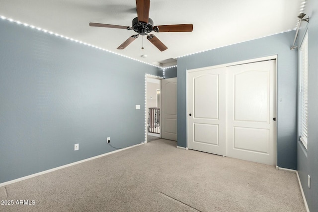 1051 E Julie Ave, San Tan Valley, AZ 85140 - unfurnished bedroom featuring a closet, baseboards, a ceiling fan, and light colored carpet