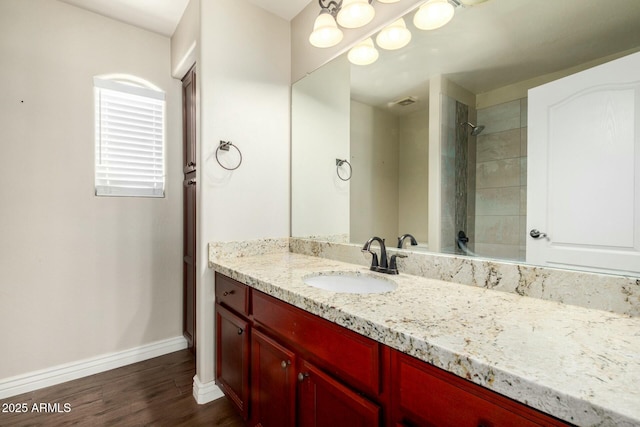 1051 E Julie Ave, San Tan Valley, AZ 85140 - bathroom with wood finished floors, vanity, baseboards, and tiled shower