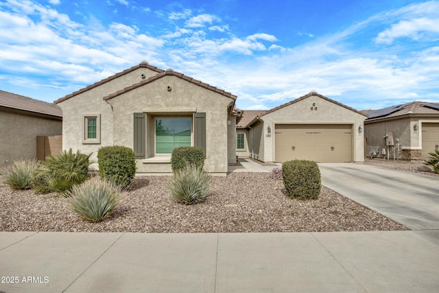 mediterranean / spanish home with driveway, an attached garage, a tiled roof, and stucco siding