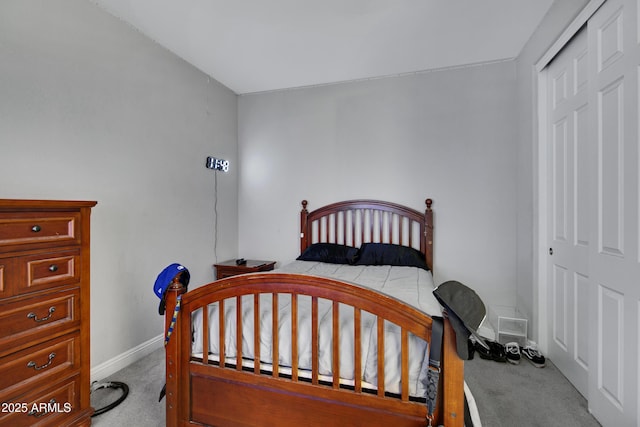 carpeted bedroom with baseboards and a closet