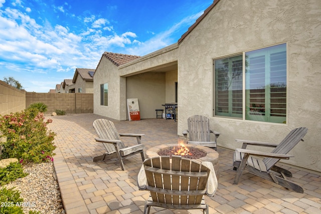view of patio / terrace with a fenced backyard and a fire pit