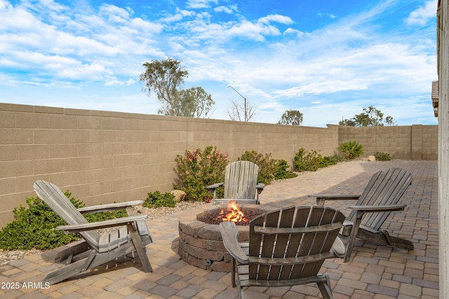 view of patio with an outdoor fire pit and a fenced backyard
