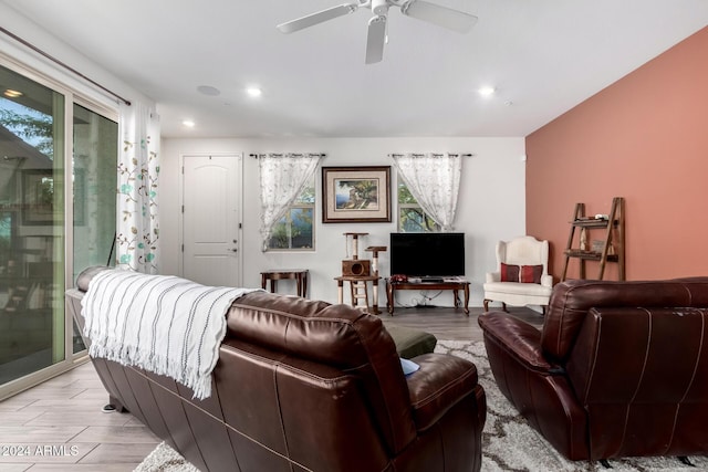 living room featuring ceiling fan, light hardwood / wood-style flooring, and a healthy amount of sunlight