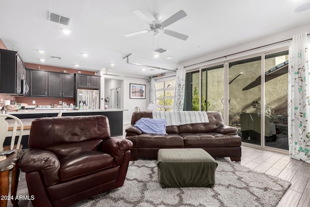 living room featuring ceiling fan and light hardwood / wood-style flooring