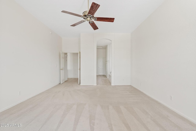 4701 W Fallen Leaf Ln, Glendale, AZ 85310 - unfurnished bedroom featuring arched walkways, light carpet, and a ceiling fan