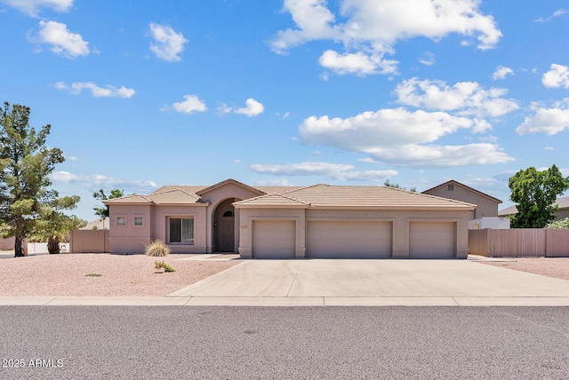 4701 W Fallen Leaf Ln, Glendale, AZ 85310 - view of front of property featuring concrete driveway, a garage, a tiled roof, and stucco siding