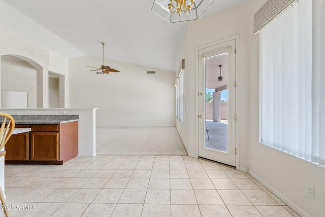 4701 W Fallen Leaf Ln, Glendale, AZ 85310 - unfurnished dining area with light colored carpet, vaulted ceiling, a ceiling fan, light tile patterned floors, and a chandelier