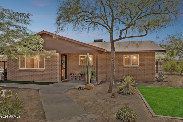 view of front of home featuring a patio and a yard