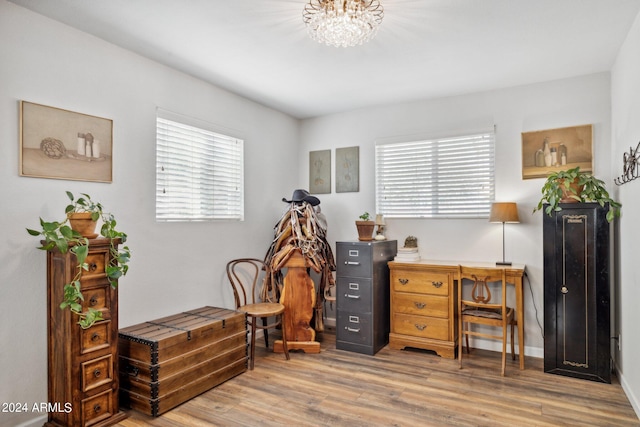 office area with hardwood / wood-style flooring and an inviting chandelier