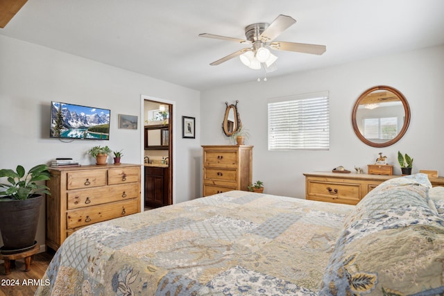 bedroom featuring ceiling fan, wood-type flooring, and ensuite bath