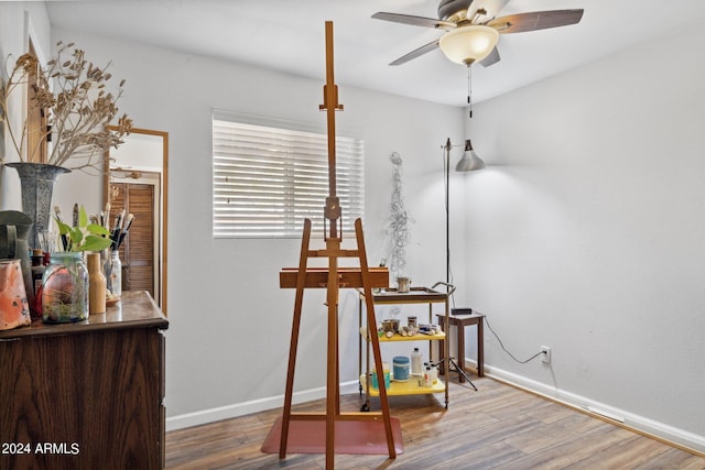 interior space featuring wood-type flooring and ceiling fan