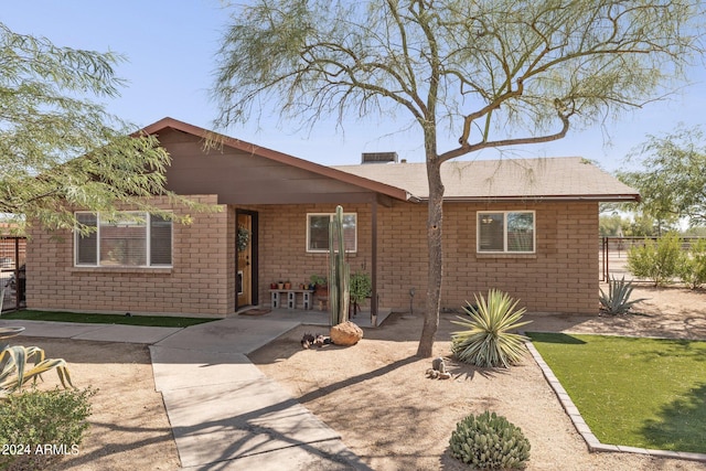 ranch-style home with a patio area