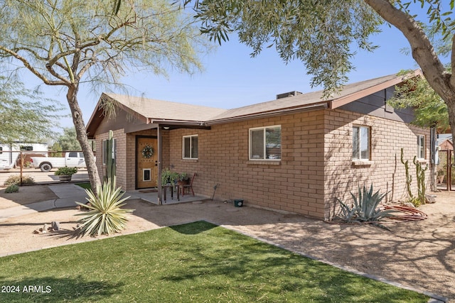 view of front facade with a patio and a front lawn