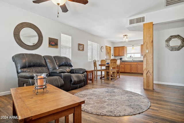 living room with sink, ceiling fan, and dark hardwood / wood-style flooring