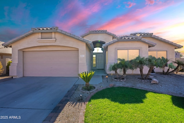 mediterranean / spanish-style home with a garage