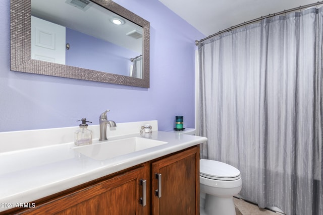 bathroom featuring walk in shower, vanity, and toilet