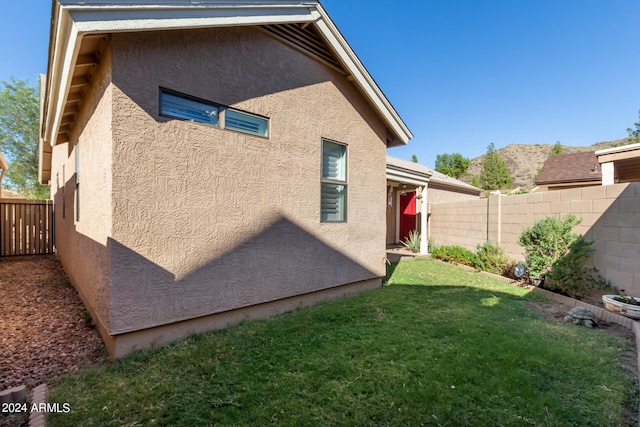 rear view of property featuring a lawn