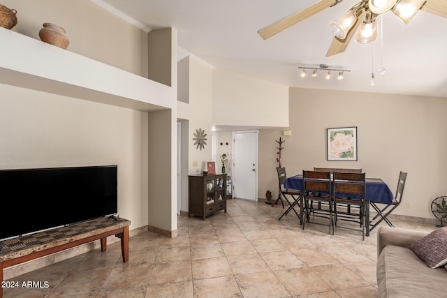 living room featuring vaulted ceiling and ceiling fan