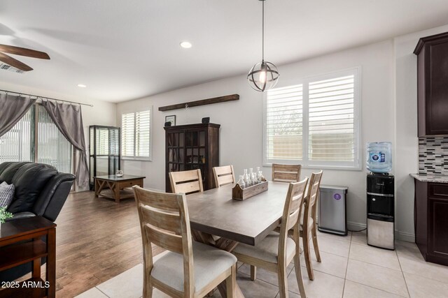 dining room with light tile patterned flooring, visible vents, a ceiling fan, and recessed lighting