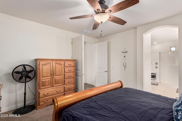 bedroom with arched walkways, ceiling fan, visible vents, and baseboards