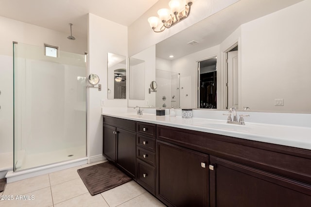 full bathroom with double vanity, visible vents, a sink, a shower stall, and tile patterned flooring