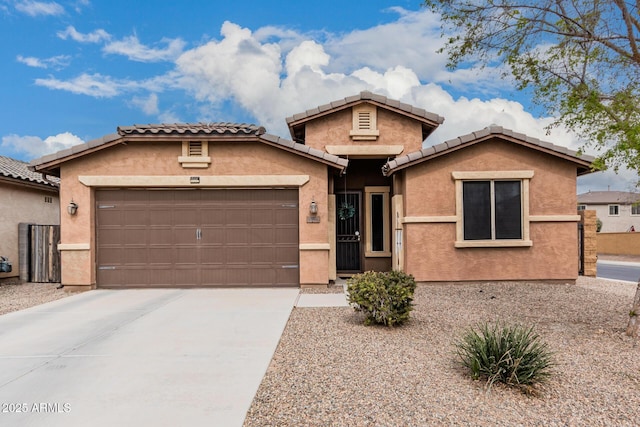 view of front of home with a tile roof, driveway, an attached garage, and stucco siding