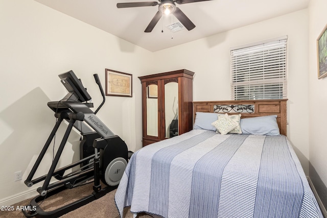 carpeted bedroom featuring ceiling fan, visible vents, and baseboards