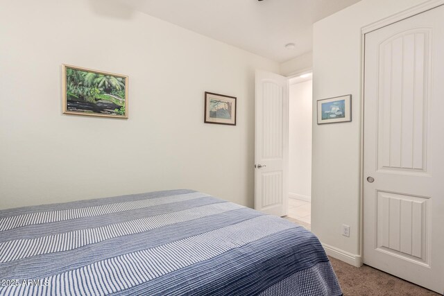 bedroom with light carpet and baseboards