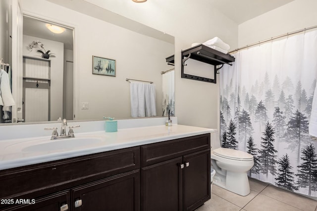 bathroom with vanity, toilet, and tile patterned floors