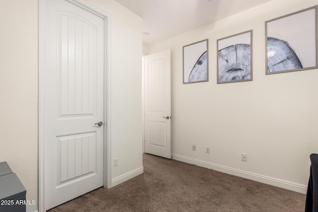 unfurnished bedroom featuring carpet and baseboards