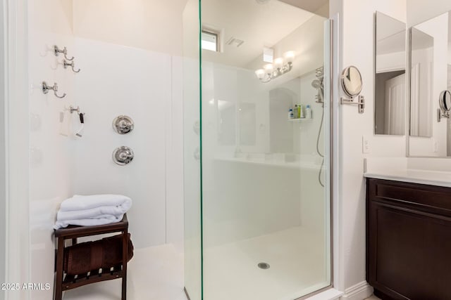 bathroom with a shower stall and vanity